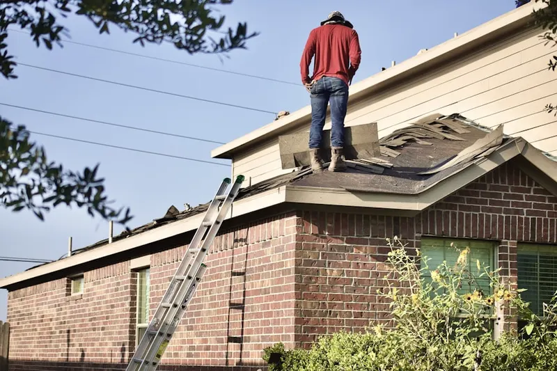 Professional roofer working on a residential roof in Avon Park North